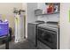 Modern laundry room featuring a Whirlpool washer and dryer set, with a hot water heater, and storage shelves at 105 Windsor Springs Rd., Conway, SC 29526