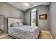 Cozy bedroom with a large window, ceiling fan, neutral paint and a comfortable bed at 109 Pheasant Run Dr., Murrells Inlet, SC 29576
