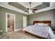 Main bedroom with trey ceiling, fan, neutral carpet and a main bathroom at 109 Pheasant Run Dr., Murrells Inlet, SC 29576