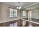 Traditional dining room featuring hardwood floors, a large mirror accent wall, and crown molding at 109 Pheasant Run Dr., Murrells Inlet, SC 29576