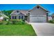 Charming single-story home featuring a lush landscaped front yard, a brick facade, and a two-car garage at 109 Pheasant Run Dr., Murrells Inlet, SC 29576