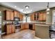 Well-equipped kitchen featuring wood cabinets, tiled floors, and stainless steel appliances at 109 Pheasant Run Dr., Murrells Inlet, SC 29576