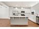 Modern kitchen with stainless steel appliances, white cabinets, and a large island at 1095 Nw Forest Bend Dr., Calabash, NC 28467