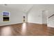 Open-concept living room with wood-look floors and staircase is filled with natural light at 1095 Nw Forest Bend Dr., Calabash, NC 28467