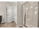 Bathroom featuring glass-enclosed shower, soaking tub, and neutral tile flooring at 1095 Nw Forest Bend Dr., Calabash, NC 28467