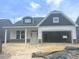 Charming single-story home with a two-car garage, stone accents, and light gray siding at 1105 Nw Forest Bend Dr., Calabash, NC 28467