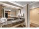 Bathroom with granite vanity, large mirror, and view into the kitchen at 1105 S Ocean Blvd. # 502, Myrtle Beach, SC 29577