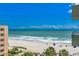 Picturesque ocean view from building featuring beach, palm trees, and building at 1105 S Ocean Blvd. # 502, Myrtle Beach, SC 29577
