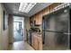 Efficient kitchen features wooden cabinets, black appliances, and a view into the living area at 1105 S Ocean Blvd. # 502, Myrtle Beach, SC 29577