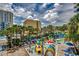 Aerial view of outdoor aquatic park featuring a play area, a pool and several lounge chairs at 1105 S Ocean Blvd. # 502, Myrtle Beach, SC 29577