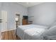 Bedroom with neutral walls, light streaming in, and view to ensuite bathroom at 1130 Ganton Way, Myrtle Beach, SC 29588