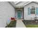 Charming front entrance with a teal door, lovely wreath, and colorful flower bed at 1130 Ganton Way, Myrtle Beach, SC 29588