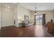 Bright living room with wood floors, ceiling fan, and sliding glass door to outdoor space at 1130 Ganton Way, Myrtle Beach, SC 29588