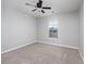 Bright bedroom featuring neutral walls, carpet, and a ceiling fan providing a relaxing atmosphere at 117 Butkus Dr. # 5, Myrtle Beach, SC 29588