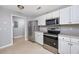 Well-lit kitchen featuring stainless steel appliances and ample cabinet space at 117 Butkus Dr. # 5, Myrtle Beach, SC 29588