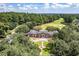 A stunning aerial view of an estate home with beautiful landscaping, a circular driveway, and mature trees at 120 Wraggs Ferry Rd., Georgetown, SC 29440