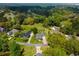 An aerial view showcases well-manicured lawns and landscaping, mature trees, and charming homes in a desirable neighborhood at 120 Wraggs Ferry Rd., Georgetown, SC 29440