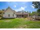 Expansive backyard featuring a covered patio, lush lawn, mature trees, and chicken coop at 120 Wraggs Ferry Rd., Georgetown, SC 29440