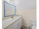 Clean bathroom with white vanity, marble countertop, and framed mirror with updated fixtures at 120 Wraggs Ferry Rd., Georgetown, SC 29440