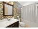 Bright bathroom featuring a vibrant jungle-themed wallpaper, white vanity, and shower with curtain at 120 Wraggs Ferry Rd., Georgetown, SC 29440