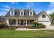 Charming home with three dormer windows, covered front porch, and landscaped yard at 120 Wraggs Ferry Rd., Georgetown, SC 29440