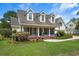 Charming home with three dormer windows, covered front porch, and mature landscaping at 120 Wraggs Ferry Rd., Georgetown, SC 29440