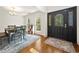 Home entry with a view of the front door and dining area with wood floors and a blue rug at 120 Wraggs Ferry Rd., Georgetown, SC 29440