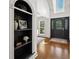 Foyer entry showcases an arched bookshelf, wood floors, and decorative stained glass front door at 120 Wraggs Ferry Rd., Georgetown, SC 29440