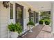 A close up of the front door with leaded glass, planters, and brick porch at 120 Wraggs Ferry Rd., Georgetown, SC 29440