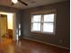 Bright bedroom with hardwood floors, natural light from the windows, and an ensuite bathroom at 1208 Mackie Circle, Myrtle Beach, SC 29579