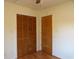Bright bedroom with wood flooring, spacious closet, and ample natural light, perfect for relaxation and personal space at 1208 Mackie Circle, Myrtle Beach, SC 29579