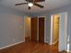 Bedroom featuring wood flooring, neutral walls, a window, closet and ceiling fan creating a comfortable, functional living space at 1208 Mackie Circle, Myrtle Beach, SC 29579