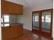Dining area with wood floors, granite-topped breakfast bar, and glass-door access to sunroom at 1208 Mackie Circle, Myrtle Beach, SC 29579