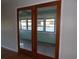 View through double glass doors to sun room with ceiling fan and windowed walls at 1208 Mackie Circle, Myrtle Beach, SC 29579