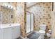 Bathroom featuring a vanity with storage, glass shower, and tropical-themed wallpaper for a unique style at 1210 A S Ocean Blvd., Surfside Beach, SC 29575