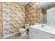 Bathroom featuring a toilet, vanity, and tropical wallpaper throughout the space at 1210 A S Ocean Blvd., Surfside Beach, SC 29575