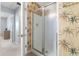 Bathroom with standup shower, palm tree wallpaper, and neutral flooring at 1210 A S Ocean Blvd., Surfside Beach, SC 29575