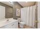 Bathroom with vanity, patterned wallpaper, white toilet, and shower with curtain at 1210 A S Ocean Blvd., Surfside Beach, SC 29575