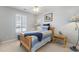 Bedroom features blue accents, ceiling fan, and bright natural light from plantation shuttered window at 1210 A S Ocean Blvd., Surfside Beach, SC 29575