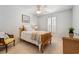 Carpeted bedroom featuring a ceiling fan, white shuttered window, and nautical art at 1210 A S Ocean Blvd., Surfside Beach, SC 29575