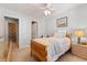 Well-lit bedroom with a single bed, ceiling fan, carpet flooring, and view to bathroom at 1210 A S Ocean Blvd., Surfside Beach, SC 29575