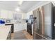 Modern kitchen featuring stainless steel appliances, white cabinetry, and wood-look flooring at 1210 A S Ocean Blvd., Surfside Beach, SC 29575