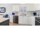 Close up of a well-appointed kitchen with white cabinets, stainless steel dishwasher, and granite counters at 1210 A S Ocean Blvd., Surfside Beach, SC 29575