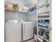 Well-organized laundry room featuring modern washer and dryer units with ample storage shelving at 1210 A S Ocean Blvd., Surfside Beach, SC 29575