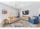 Bright living space offering comfortable seating, a ceiling fan, and a mounted television for relaxation at 1210 A S Ocean Blvd., Surfside Beach, SC 29575