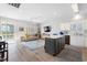 Open-concept living space with wood floors, ceiling fan, stainless appliances, and light, airy decor at 1210 A S Ocean Blvd., Surfside Beach, SC 29575