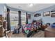 This bedroom features light blue walls, and large windows with black out curtains at 1340 Valor Rd., Conway, SC 29527