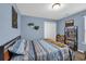 This bedroom features light blue walls and a full sized bed with blue striped bedding at 1340 Valor Rd., Conway, SC 29527