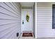 Close up shot of the front door with a cute wreath and 'Hello' mat, offering a warm welcome at 1340 Valor Rd., Conway, SC 29527