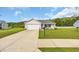 Charming single-story home featuring a well-manicured lawn, white picket fence, and attached two-car garage at 1340 Valor Rd., Conway, SC 29527